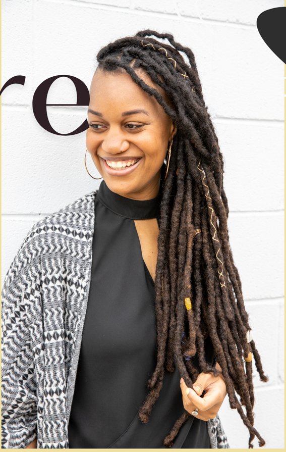 Black woman looking at the ends of her hair